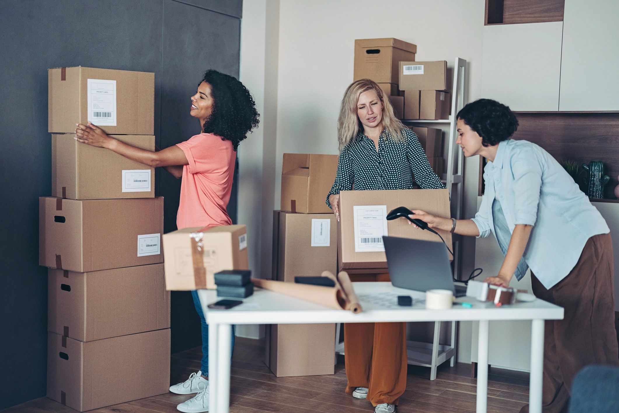 Small business owners packaging products for delivery