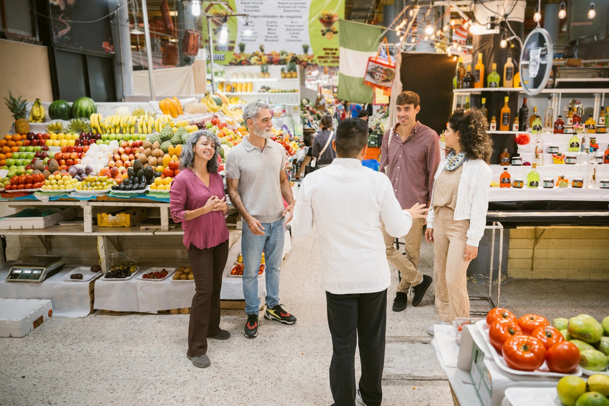 Shoppers exploring a lively market with multiple vendors